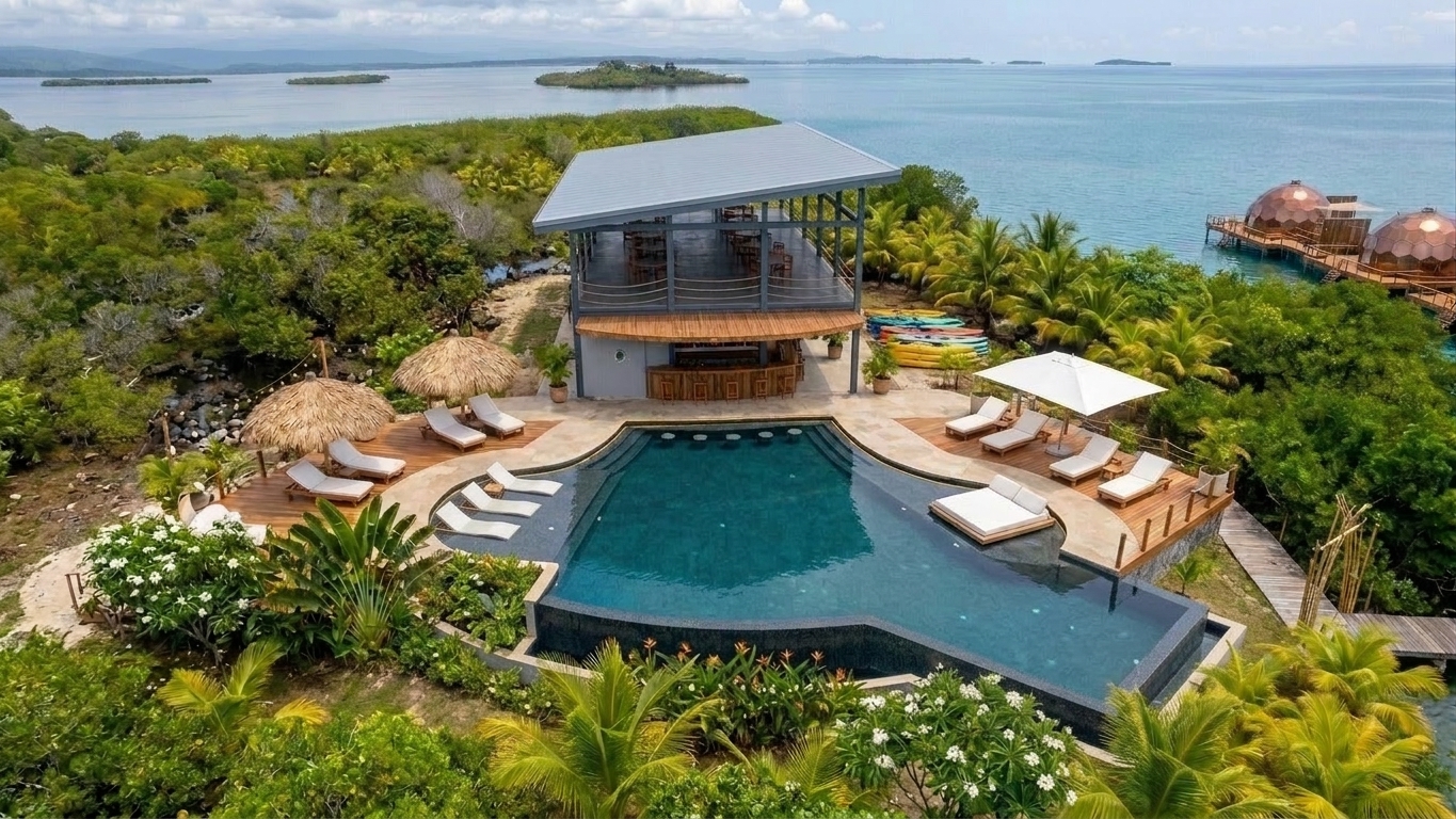 Aerial view of the private island showing the domes, dock, and community hub